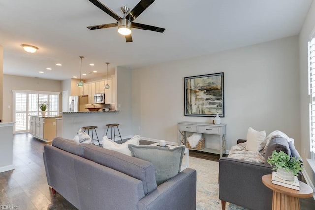 living room with dark hardwood / wood-style floors and ceiling fan