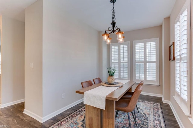 dining space with an inviting chandelier and dark hardwood / wood-style floors