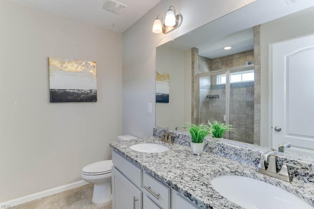 bathroom featuring toilet, vanity, tile patterned floors, and walk in shower