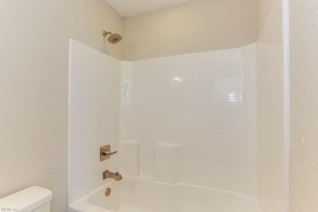 bathroom featuring  shower combination and toilet