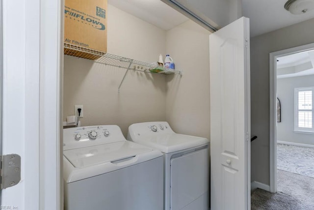 clothes washing area featuring washing machine and clothes dryer and carpet