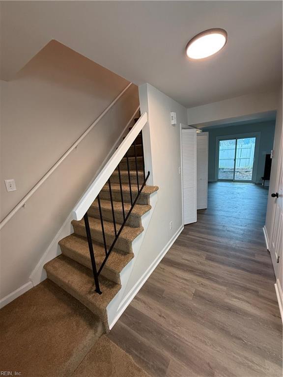 stairs with hardwood / wood-style flooring