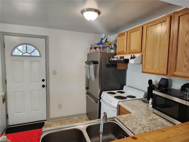 kitchen with extractor fan, butcher block counters, a sink, electric stove, and stainless steel microwave