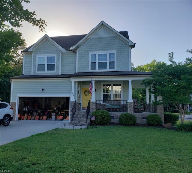 craftsman-style house featuring a porch, a lawn, a garage, stone siding, and driveway