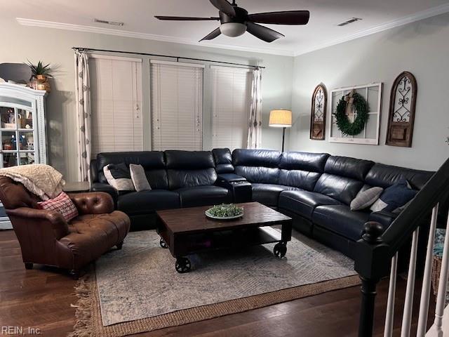 living area featuring ceiling fan, visible vents, crown molding, and wood finished floors