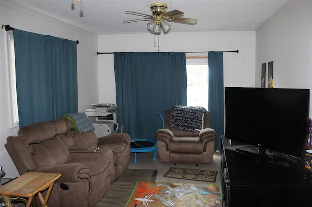 carpeted living room featuring ornamental molding, ceiling fan, and a textured ceiling