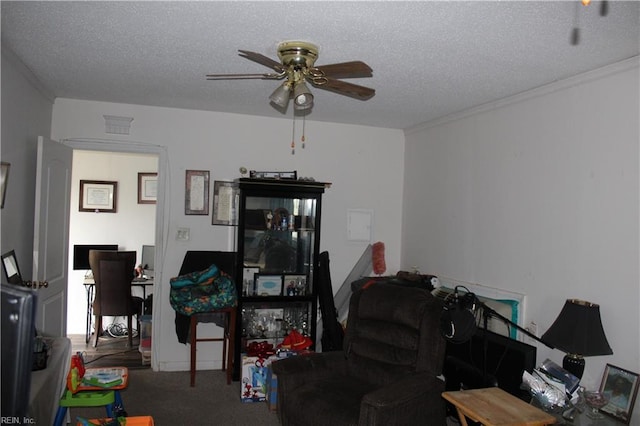 interior space with ceiling fan and a textured ceiling