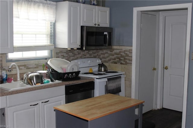 kitchen with sink, white cabinets, and appliances with stainless steel finishes