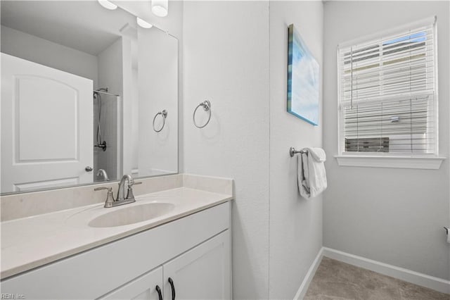 bathroom featuring vanity and a shower