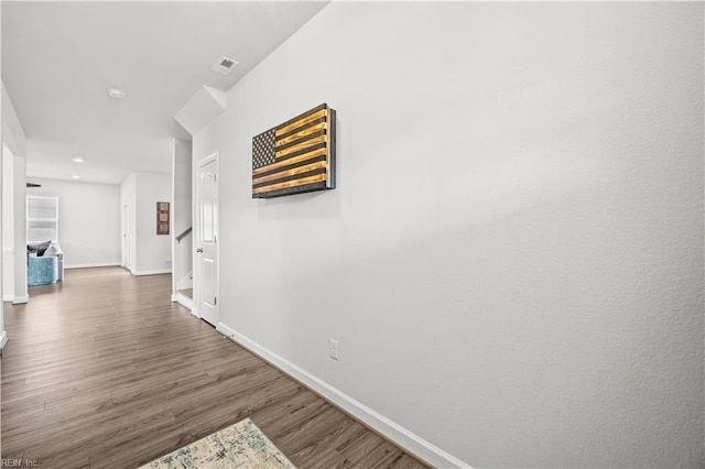 hallway with dark hardwood / wood-style floors