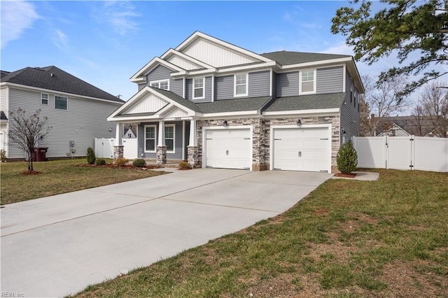 craftsman house featuring covered porch, a front yard, and a garage