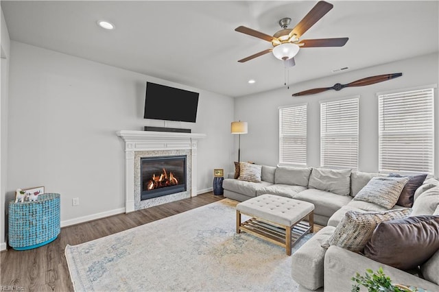 living room with ceiling fan and dark hardwood / wood-style flooring