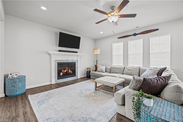 living room featuring dark wood-type flooring and ceiling fan