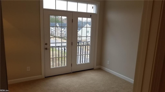 entryway featuring light colored carpet