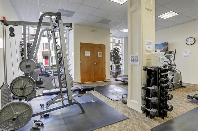 gym with a paneled ceiling