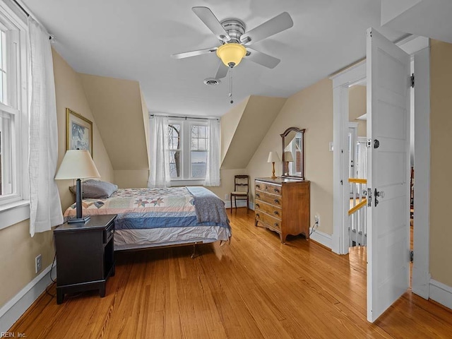 bedroom with lofted ceiling, ceiling fan, and light hardwood / wood-style flooring