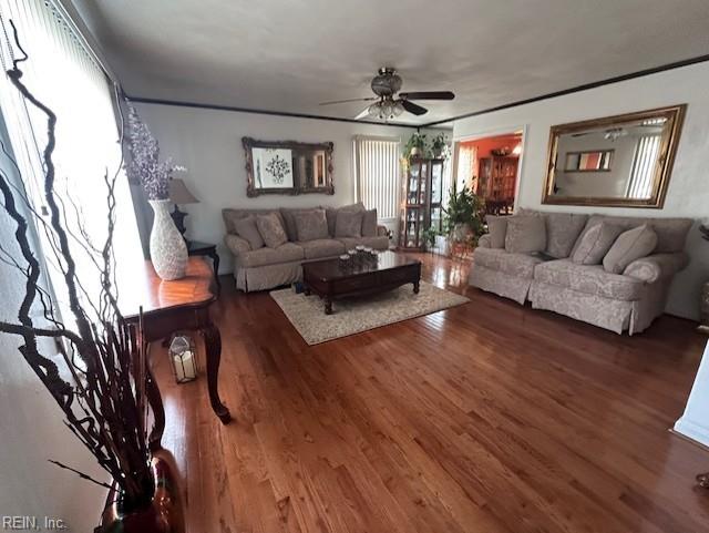 living room with ceiling fan and dark hardwood / wood-style floors