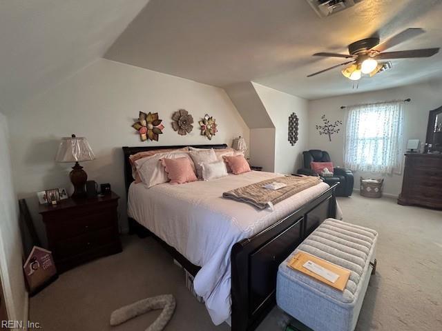 bedroom with ceiling fan, carpet flooring, and lofted ceiling