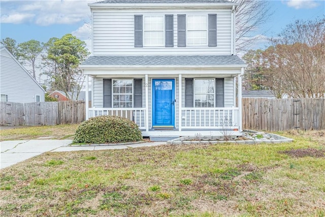 view of front of property featuring a front yard and covered porch