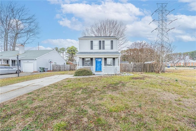 view of front of property featuring a garage, a front yard, and a porch