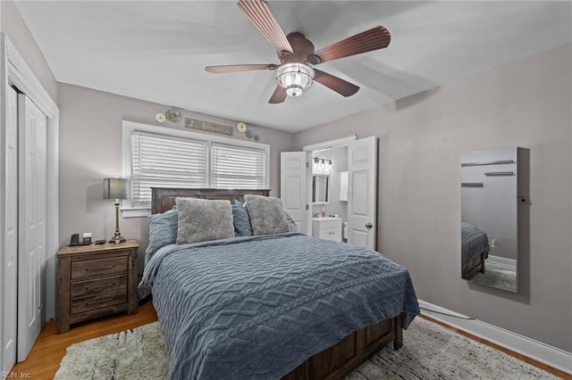 bedroom featuring ceiling fan, a closet, sink, and light hardwood / wood-style floors