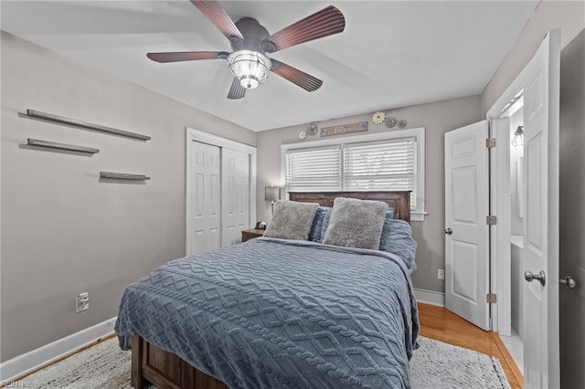 bedroom featuring ceiling fan, a closet, and light hardwood / wood-style floors