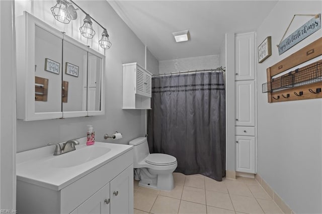 bathroom with vanity, tile patterned flooring, toilet, and walk in shower