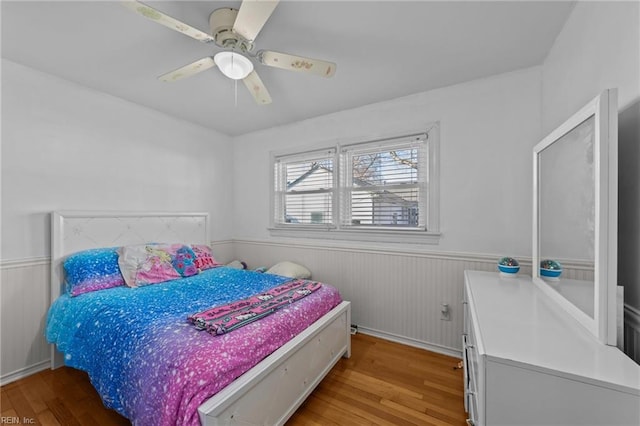 bedroom with ceiling fan and wood-type flooring