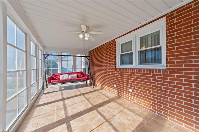 sunroom featuring ceiling fan