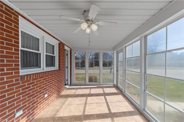 unfurnished sunroom featuring plenty of natural light and ceiling fan