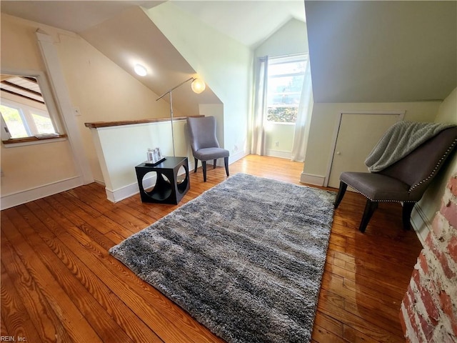 living area with hardwood / wood-style flooring and lofted ceiling