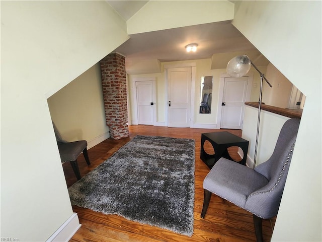 sitting room featuring hardwood / wood-style flooring and lofted ceiling