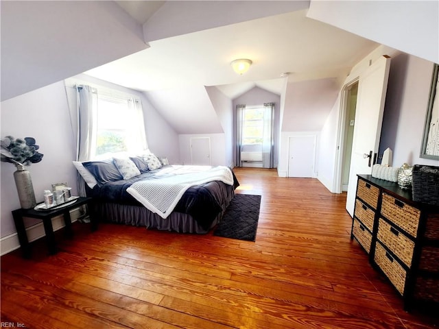 bedroom with wood-type flooring and lofted ceiling