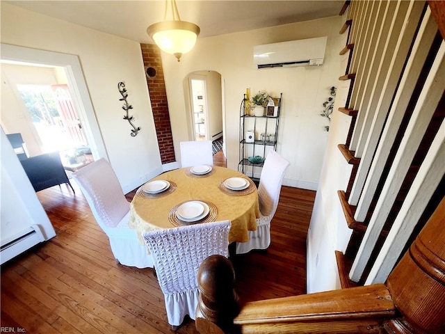 dining area featuring dark hardwood / wood-style flooring and a wall mounted AC