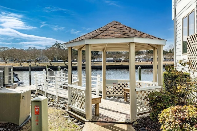 view of dock featuring a water view, central AC unit, and a gazebo