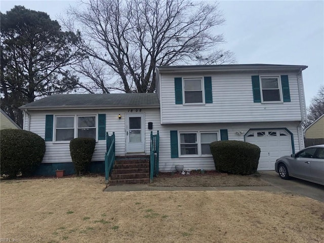 split level home with a garage and a front lawn