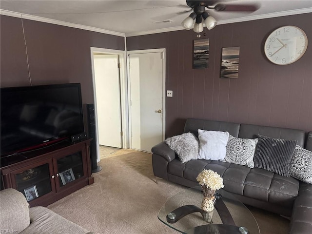 living room with crown molding, light colored carpet, and ceiling fan