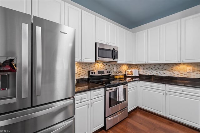 kitchen with stainless steel appliances, dark hardwood / wood-style floors, decorative backsplash, and white cabinets