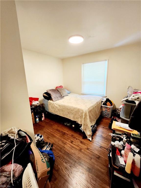 bedroom with dark hardwood / wood-style floors