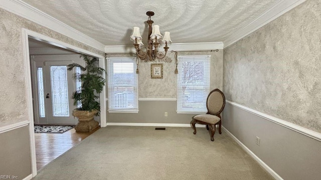 unfurnished room with crown molding, carpet floors, a notable chandelier, and a textured ceiling