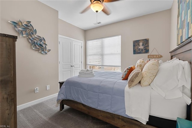 bedroom with visible vents, baseboards, ceiling fan, carpet flooring, and a closet