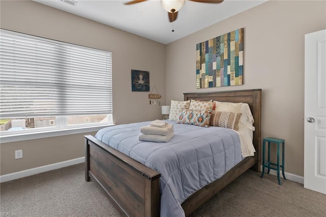 bedroom with ceiling fan, baseboards, and carpet flooring