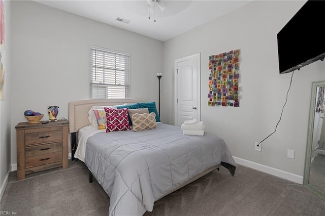 carpeted bedroom with baseboards, visible vents, and a ceiling fan