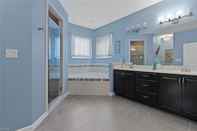 full bath featuring double vanity, a stall shower, a sink, and tile patterned floors