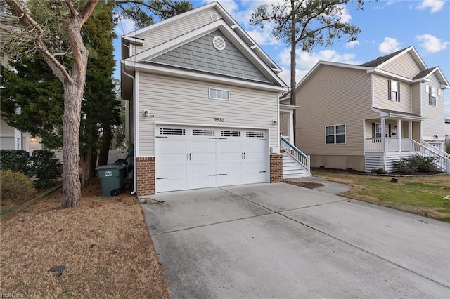 view of front of house with a porch, concrete driveway, brick siding, and an attached garage