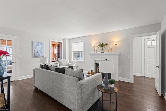 living room with a fireplace and dark wood-type flooring