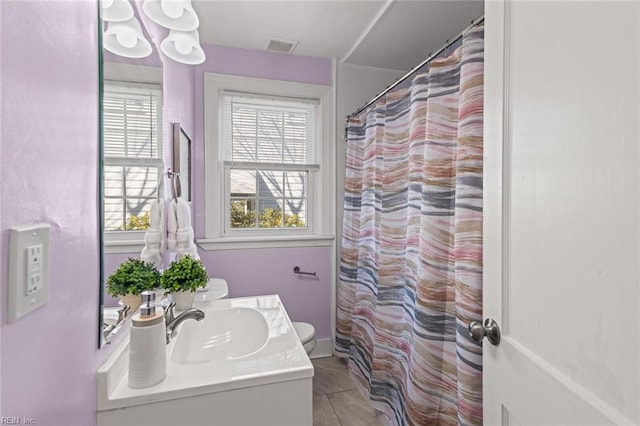 bathroom with toilet, vanity, curtained shower, and tile patterned floors