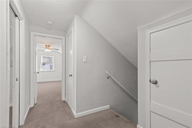 interior space with carpet and vaulted ceiling