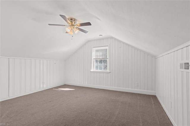 additional living space featuring ceiling fan, vaulted ceiling, and carpet floors