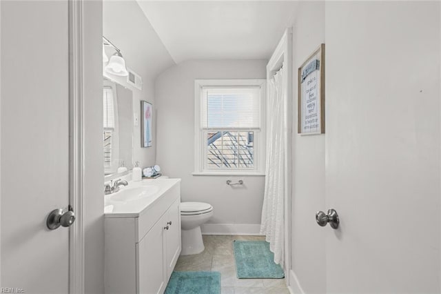 bathroom featuring vanity, vaulted ceiling, tile patterned flooring, and toilet